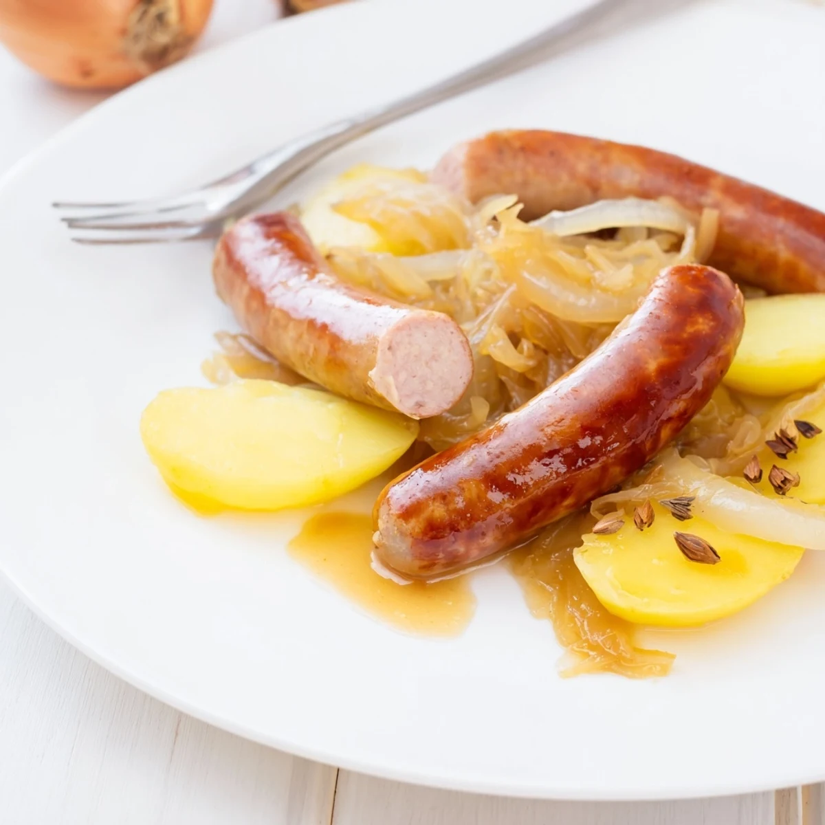 Herzhaftes Sauerkraut und Bratwürste, perfekt für ein gemütliches Abendessen.  