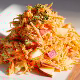 Refreshing carrot and apple slaw dish served in a vibrant bowl.  