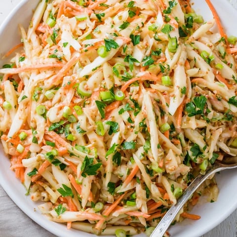 Crisp Sauerkraut and Apple Slaw with fresh parsley and vibrant green onions.  